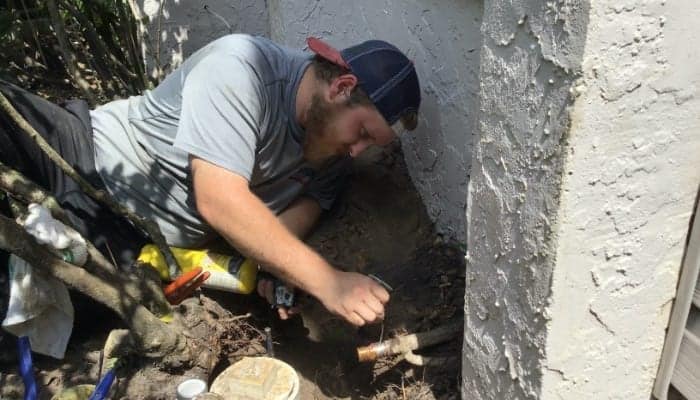 plumber-working-outside-home